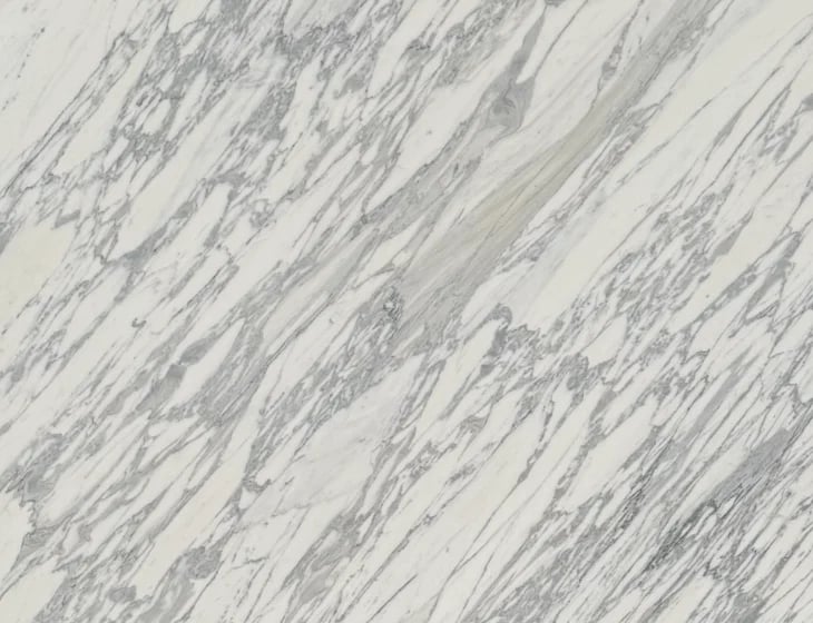 Close-up of white marble surface with gray veining and natural texture patterns