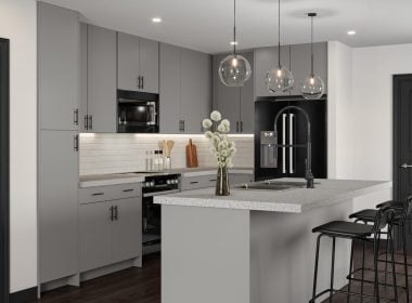 Modern kitchen with gray cabinets, white marble countertops, black stainless steel appliances, pendant lighting, and island seating.