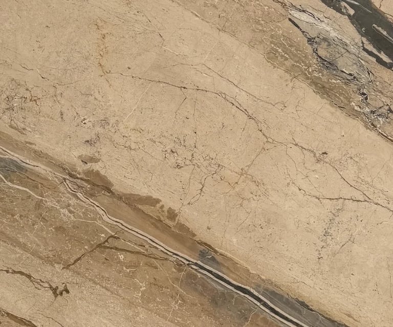 Aerial view of desert terrain with a thin paved road cutting through sandy, cracked earth