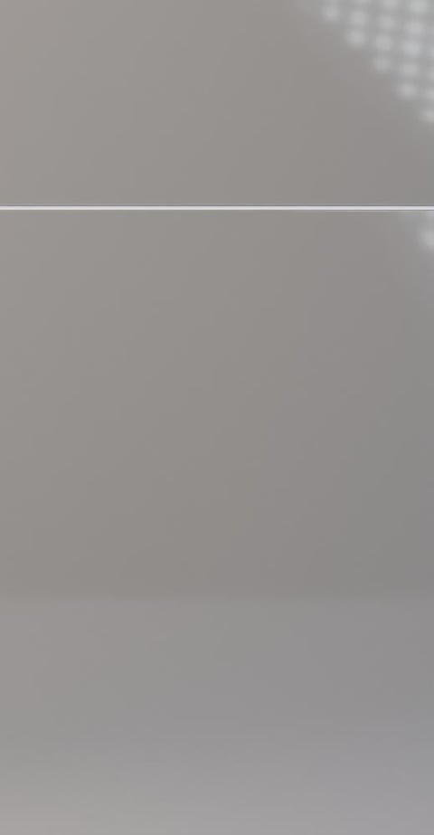 Loading screen or blank gray interface with horizontal line divider and faint white dots in upper right corner