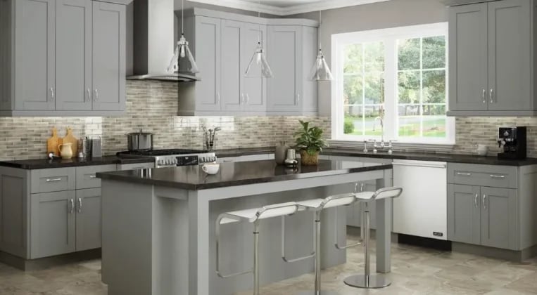 Modern gray kitchen with island, gray cabinetry, stainless steel appliances, and pendant lighting over the counter seating area